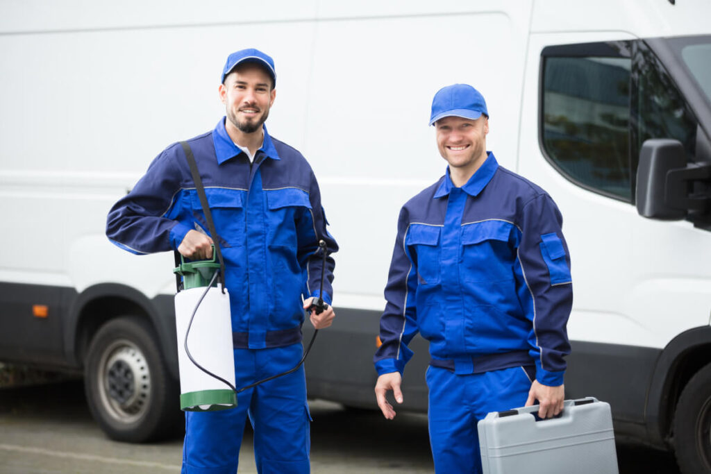 two pest control workers happy to do their job pest exterminating